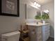 This bathroom offers a well-lit vanity, a spacious mirror, and functional storage solutions at 6650 W Warm Springs Rd # 2159, Las Vegas, NV 89118
