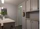 Well-lit bathroom with a sink, vanity, grey flooring, and storage cabinets at 6650 W Warm Springs Rd # 2159, Las Vegas, NV 89118