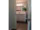 A bathroom features a white vanity with a sink, cabinets, and a large mirror with modern lighting at 6650 W Warm Springs Rd # 2159, Las Vegas, NV 89118
