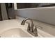 Close-up of a modern bathroom sink with sleek faucet and white countertop under a vanity mirror at 6650 W Warm Springs Rd # 2159, Las Vegas, NV 89118