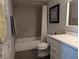 Bright bathroom featuring a shower with grey tiling, a toilet, and a white vanity at 6650 W Warm Springs Rd # 2159, Las Vegas, NV 89118