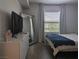 Sunlit bedroom featuring a bed, tv on dresser and a mirrored wall at 6650 W Warm Springs Rd # 2159, Las Vegas, NV 89118