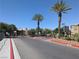 Gated community entrance with well-manicured landscaping and mature palm trees for curb appeal at 6650 W Warm Springs Rd # 2159, Las Vegas, NV 89118