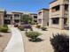 Exterior shot of multi-Gathering home showcasing balconies, desert landscaping and sidewalks at 6650 W Warm Springs Rd # 2159, Las Vegas, NV 89118