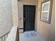 Inviting front door entrance with a welcome mat, textured wall, and secure lock at 6650 W Warm Springs Rd # 2159, Las Vegas, NV 89118