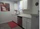The well-lit kitchen offers ample counter space with white cabinets and stainless steel appliances at 6650 W Warm Springs Rd # 2159, Las Vegas, NV 89118