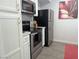 Stainless steel appliances, white cabinets, and modern finishes in kitchen at 6650 W Warm Springs Rd # 2159, Las Vegas, NV 89118