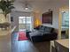 Open concept living area featuring modern furniture and access to a balcony at 6650 W Warm Springs Rd # 2159, Las Vegas, NV 89118