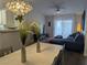Open-concept living space with dining area, chandelier, and comfortable seating at 6650 W Warm Springs Rd # 2159, Las Vegas, NV 89118