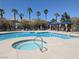 Community pool with lounge chairs, palm trees, and cabanas for residents' enjoyment at 6650 W Warm Springs Rd # 2159, Las Vegas, NV 89118