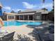 Sparkling community pool with a connecting spa and outdoor lounge chairs at 6650 W Warm Springs Rd # 2159, Las Vegas, NV 89118
