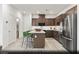 Modern kitchen featuring stainless steel appliances, a central island, and ample cabinet space at 6740 Nimbus Ave # Lot 10, Las Vegas, NV 89130