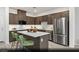 Modern kitchen featuring stainless steel appliances, a central island, and ample cabinet space at 6740 Nimbus Ave # Lot 10, Las Vegas, NV 89130