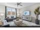 Bright living room with stylish decor, large windows, and a comfortable seating area at 6740 Nimbus Ave # Lot 10, Las Vegas, NV 89130