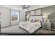 Spacious main bedroom with a ceiling fan, large window, and neutral decor for a relaxing retreat at 6740 Nimbus Ave # Lot 10, Las Vegas, NV 89130
