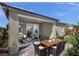 Outdoor patio area with dining table, chairs, and lush greenery, perfect for entertaining at 737 Wild Highlands Ln, Henderson, NV 89015