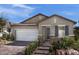 Charming single-story home featuring a two-car garage, stone accents, and desert landscaping at 737 Wild Highlands Ln, Henderson, NV 89015
