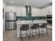 Modern kitchen with stainless steel appliances, white cabinetry, and a center island with bar seating at 737 Wild Highlands Ln, Henderson, NV 89015