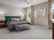 Elegant main bedroom featuring a decorative accent wall, sitting area, and ample natural light at 737 Wild Highlands Ln, Henderson, NV 89015