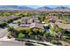 Panoramic aerial view of the home highlighting the pool, desert landscaping, and mountain views at 748 Puerto Real Ct, Las Vegas, NV 89138