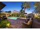 This relaxing backyard space features a pool, spa, lounge chairs, and covered patio at 748 Puerto Real Ct, Las Vegas, NV 89138