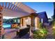 Inviting backyard with covered patio, pool, and cozy seating area at 748 Puerto Real Ct, Las Vegas, NV 89138