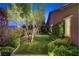 Well manicured backyard featuring grass, a garden, and perimeter landscaping at 748 Puerto Real Ct, Las Vegas, NV 89138