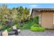 Serene backyard with lush landscaping, a well-manicured lawn, and a cozy seating area at 748 Puerto Real Ct, Las Vegas, NV 89138