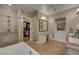 Clean bathroom featuring glass enclosed shower and soaking tub with a door leading to a walk in closet at 748 Puerto Real Ct, Las Vegas, NV 89138