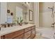 This bathroom has double sinks, a bathtub and shower and a neutral color palette at 748 Puerto Real Ct, Las Vegas, NV 89138