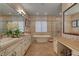 Spacious bathroom with double vanity, soaking tub, glass shower, and ample counter space at 748 Puerto Real Ct, Las Vegas, NV 89138