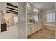 Bright bathroom with double vanity, soaking tub, and stone accents for a luxurious feel at 748 Puerto Real Ct, Las Vegas, NV 89138
