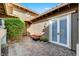 This courtyard has a paved floor, decorative shrubbery and an outdoor bench at 748 Puerto Real Ct, Las Vegas, NV 89138