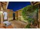 Courtyard with brick pavers, accent lighting, and lush green shrubbery at 748 Puerto Real Ct, Las Vegas, NV 89138