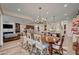 Bright dining room open to the kitchen, featuring modern lighting, wood floors and designer rug at 748 Puerto Real Ct, Las Vegas, NV 89138