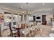 Spacious dining area with chandelier, access to outdoor patio, and seating for six at 748 Puerto Real Ct, Las Vegas, NV 89138
