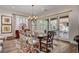 Dining room features a chandelier, large windows, a patterned rug, and seating for six at 748 Puerto Real Ct, Las Vegas, NV 89138