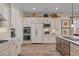 Spacious kitchen with white cabinetry, stainless steel appliances, granite countertops, and hardwood floors at 748 Puerto Real Ct, Las Vegas, NV 89138