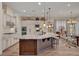 Kitchen features large island with granite countertop, pendant lights, and stainless steel appliances at 748 Puerto Real Ct, Las Vegas, NV 89138