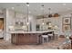 Kitchen features a large island with seating, stainless steel appliances, and custom white cabinets at 748 Puerto Real Ct, Las Vegas, NV 89138