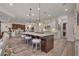 Open kitchen featuring a large island with seating, stainless appliances, and access to second bar area at 748 Puerto Real Ct, Las Vegas, NV 89138