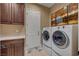Functional laundry room featuring front-loading washer and dryer, cabinets, and folding counter at 748 Puerto Real Ct, Las Vegas, NV 89138