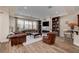 Spacious living room featuring a fireplace, built-in shelving, and a large window with natural light at 748 Puerto Real Ct, Las Vegas, NV 89138