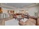 Open-concept living room with a fireplace open to the kitchen, and beautiful hardwood flooring at 748 Puerto Real Ct, Las Vegas, NV 89138