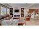 Elegant living room with custom built-ins, fireplace, and comfortable seating, perfect for entertaining at 748 Puerto Real Ct, Las Vegas, NV 89138