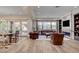 Open-concept living room with a fireplace, built-in shelving, and lots of natural light at 748 Puerto Real Ct, Las Vegas, NV 89138