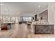 Open-concept living space with hardwood floors, spacious layout, and seamless flow to kitchen at 748 Puerto Real Ct, Las Vegas, NV 89138