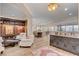 Open-concept living room with wood floors, large built-in bookcase, recessed lighting, and access to dining area at 748 Puerto Real Ct, Las Vegas, NV 89138