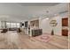 Bright living room with hardwood floors, a bar, a round mirror and comfortable seating area, perfect for entertaining at 748 Puerto Real Ct, Las Vegas, NV 89138