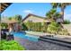 Lush backyard with a sparkling pool, spa, and stone patio, perfect for outdoor entertaining at 748 Puerto Real Ct, Las Vegas, NV 89138